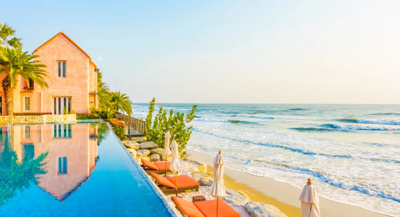 Beach resort with infinity pool at sunrise